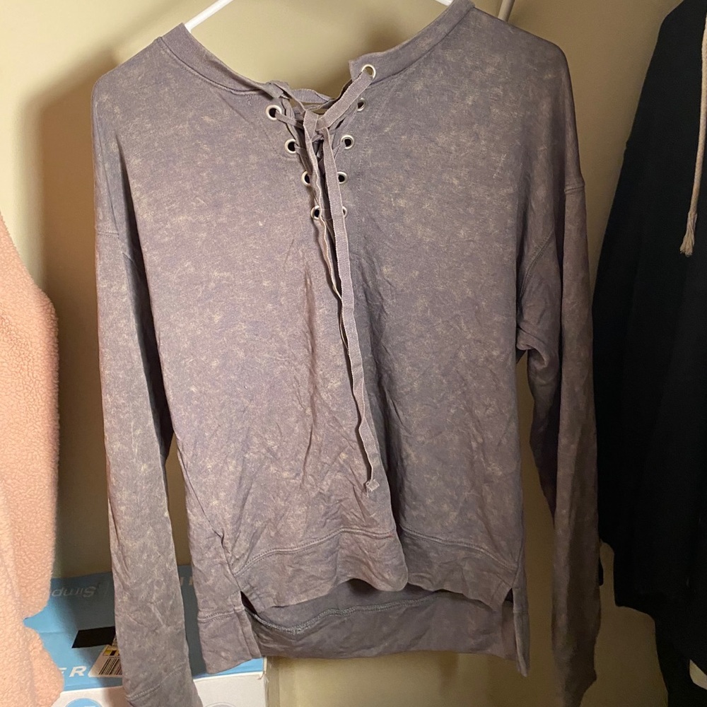 Grey long sleeve with cris cross near the neck